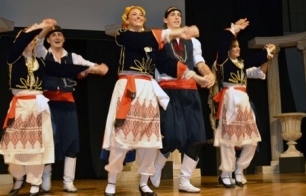 Greek dancers on stage. (greekfestival.org/faith-culture/dance-program)