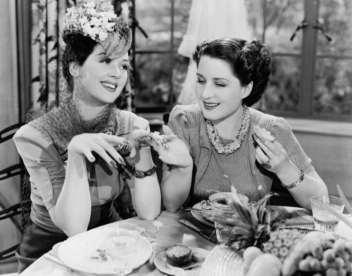 Two women at lunch. . Rosalind Russell in the movie "The Women" (USPD. pub date, publicity still/Commons.wikimedia.org))
