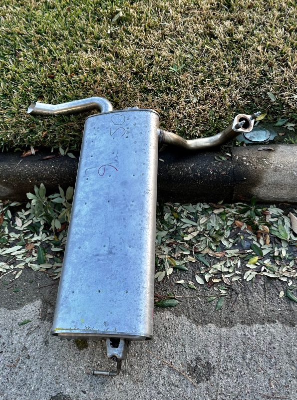 Muffler in distress kicked to the curb and helpless. (© image copyrighted, all rights reserved, no permissions granted)