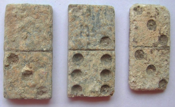 Three lead dominos, probably dating to the 18th century. The dominos are cast and each has a numerical value in dots, divided with a line down the centre, as on modern dominos. (Image: Portable Antiquities Scheme/Trustees of the British Museum/Commons.wikimedia.org)